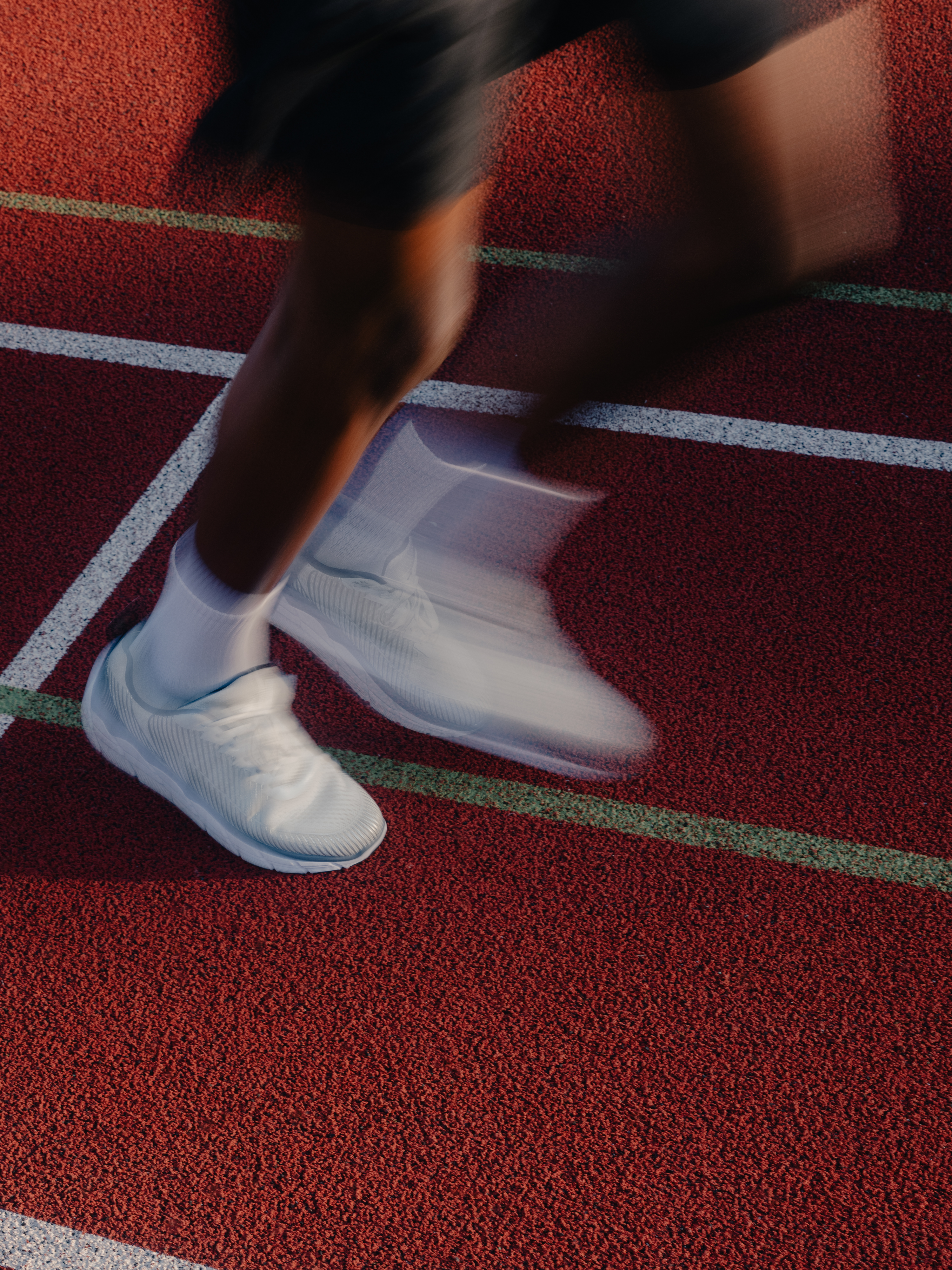 Runner feet on a red track